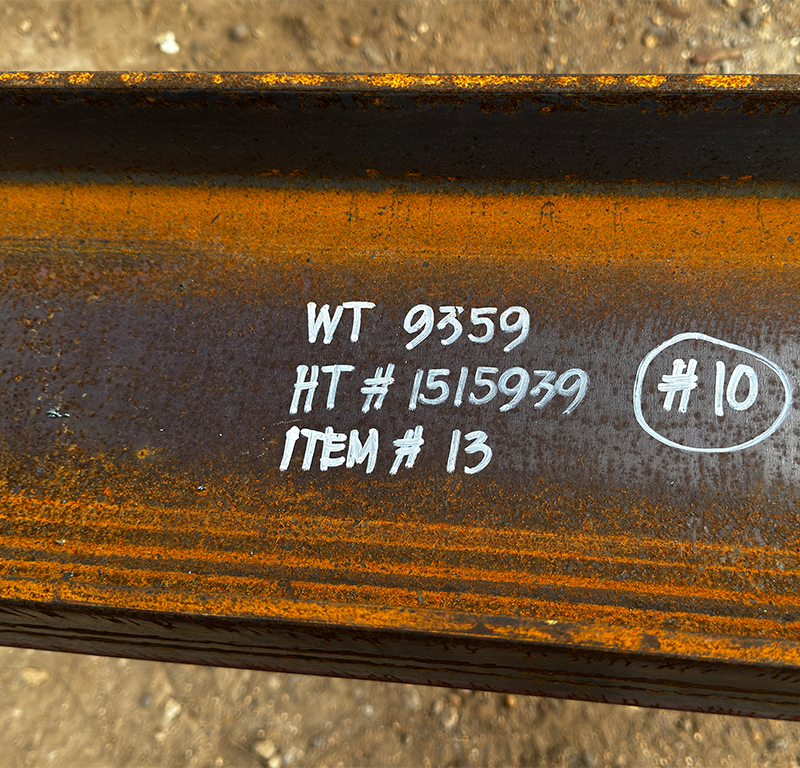 Close-up of structural steel marked with item ID for offshore material traceability.